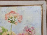 an oil painting of flowers in a gold frame on a wall