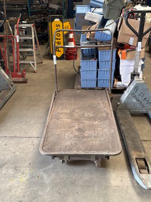 an image of a dolly truck in a warehouse
