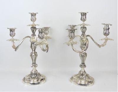 pair of silver plated candelabs with flowers and leaves