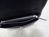 a black purse that is open on a table