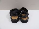 a pair of black shoes on a white surface