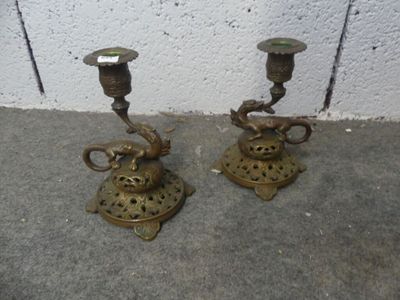 two candles that are sitting on the ground