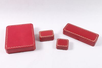 three small red boxes with red stitching on them sitting on a white surface