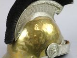 a gold helmet with a black and red mohawk on it