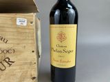 a bottle of wine sitting next to a wooden box