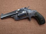 a gun that is on the ground on a brown surface