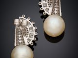 a pair of pearl and diamond earrings
