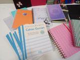 many different types of notebooks sitting on a table