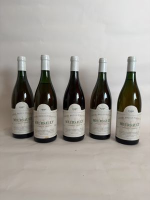 six bottles of wine are lined up on a table