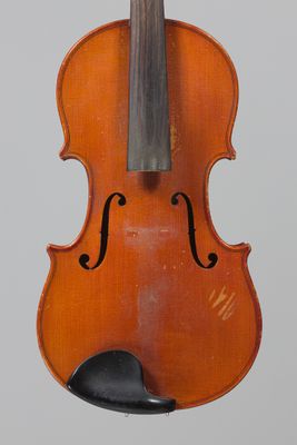 an old violin with a bow hanging from it ' s back
