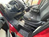 a red car with a black seat and a radio in it