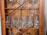 a glass cabinet with a lot of glasses in it