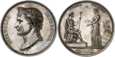 an image of a silver coin with a woman and a man on it