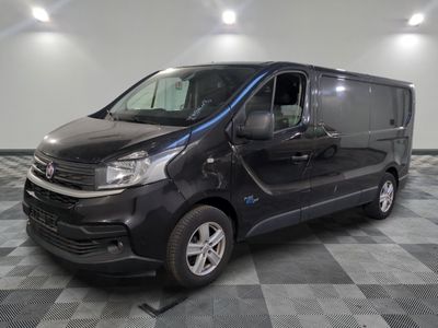 the black van is parked on a checkered tile floor
