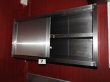a stainless steel wall mounted oven in a red kitchen
