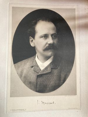 an old photo of a man with a mustache in a suit and tie