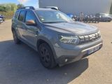 the grey dacia is parked in a parking lot with other cars