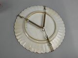 a clock that is on a plate on the table
