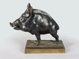 bronze sculpture of a boar on a wooden base on a white background