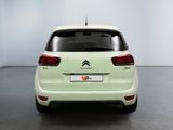 the rear end of a white citrole parked in a room
