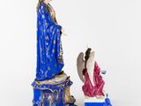 a figurine of the virgin and an angel on a pedestal