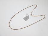 a close up of a necklace with a tag attached to it