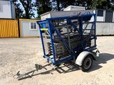 a small trailer with a trailer attached to it in the dirt