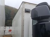 a picture of a truck that is parked next to a trailer