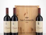 three bottles of wine in front of a wooden box on a table