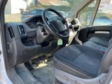 the interior of a van with the door open and the driver ' s seat down
