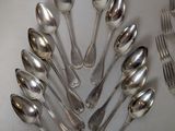 a lot of silver spoons and forks arranged in a circle