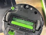 a robot that is sitting on a table next to a laptop