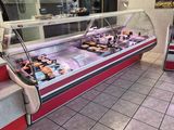 a display case with a variety of pastries in it