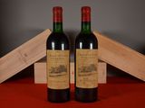 two bottles of wine sitting next to each other on a table