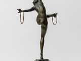 a bronze statue of a woman holding a rope on a marble base