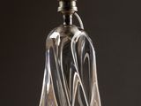 a glass bottle that is sitting on top of a table