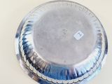 a silver plate on a table with a white background