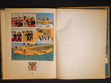 an open book with a picture of a boat in it
