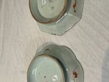 two cups and saucers sitting on a table