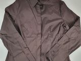 the shirt is brown and has a button down collar