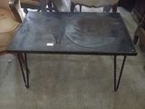 a black table with a black top and black hairpin legs