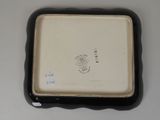 a small black and white plate with a picture on it