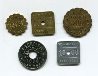 four different types of coins on a white surface