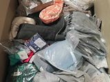 a cardboard box filled with many different types of clothing