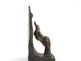 bronze sculpture of a man on a horse on a rock