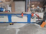 a picture of a machine that is cutting a piece of wood