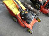 two lawn mowers that are sitting next to each other