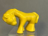 a yellow horse that is standing on top of a table