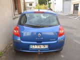 a small blue car parked on the side of the road