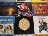 many different album covers on the table together